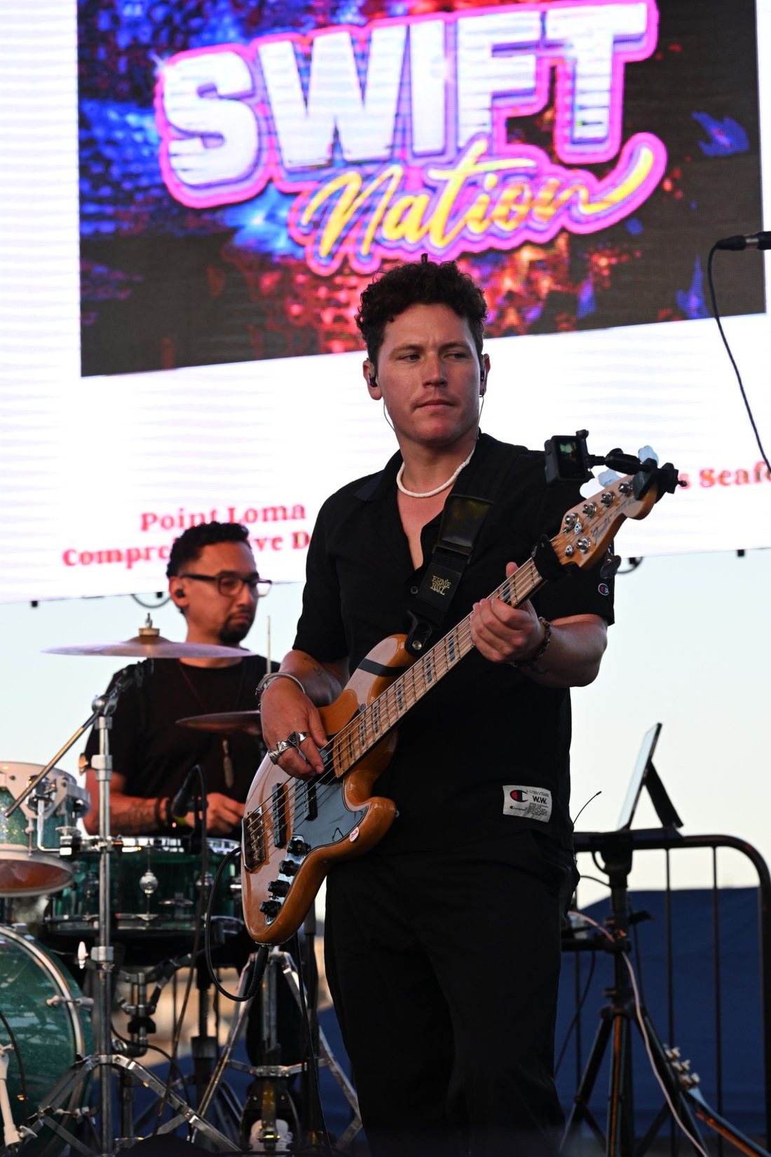 Bassist playing on an outdoor stage