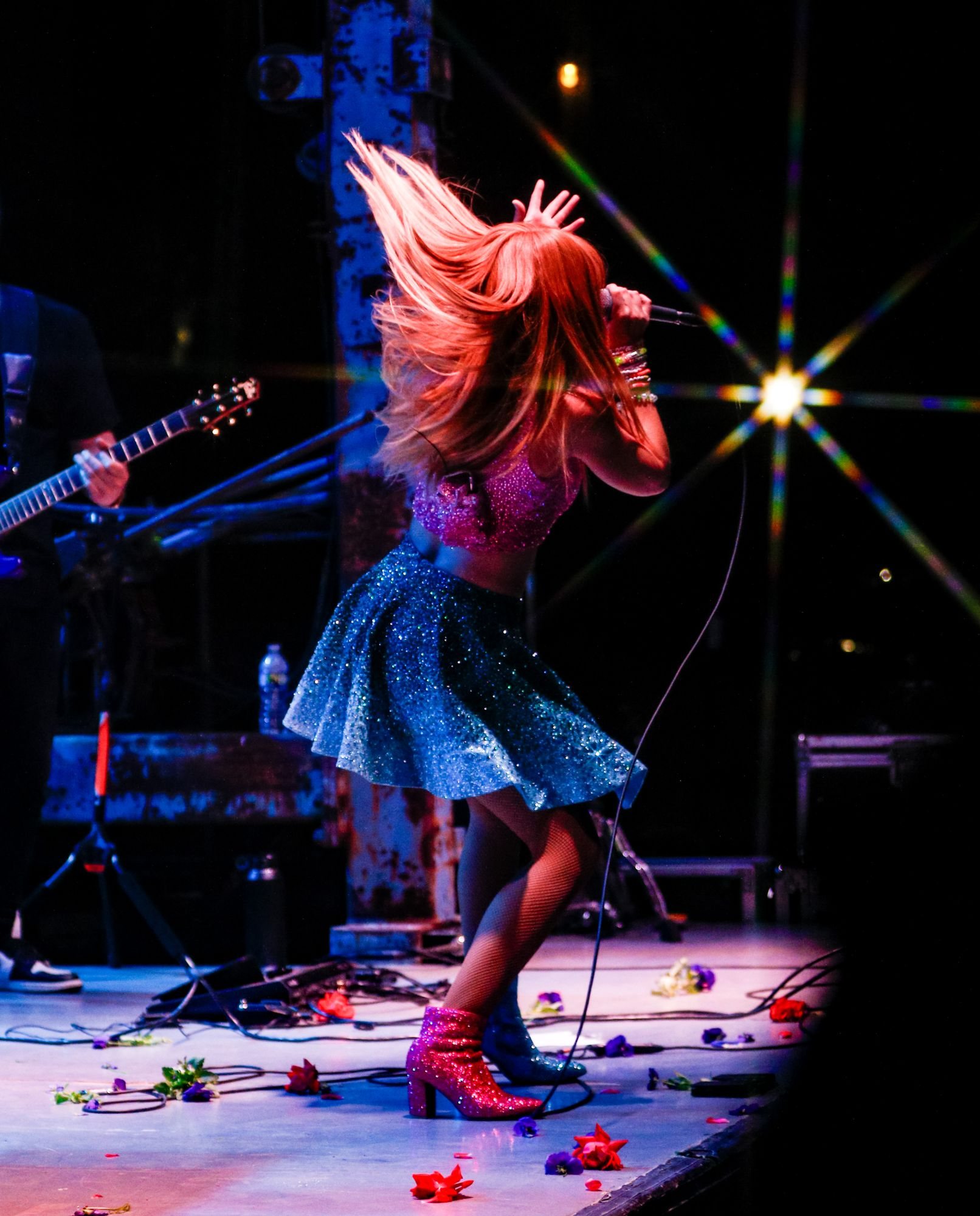 Melody Ebner whipping her hair back on stage